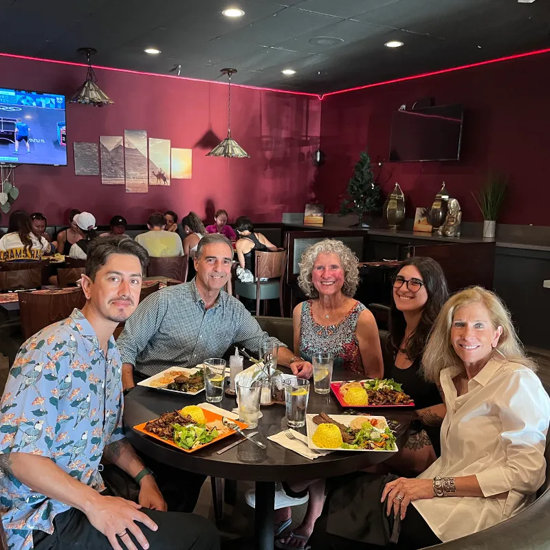 Elena and her family enjoying a meal at a restaurant
